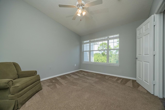 unfurnished room with carpet, ceiling fan, a textured ceiling, and vaulted ceiling