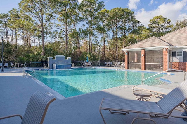 view of pool with a patio area and a sunroom