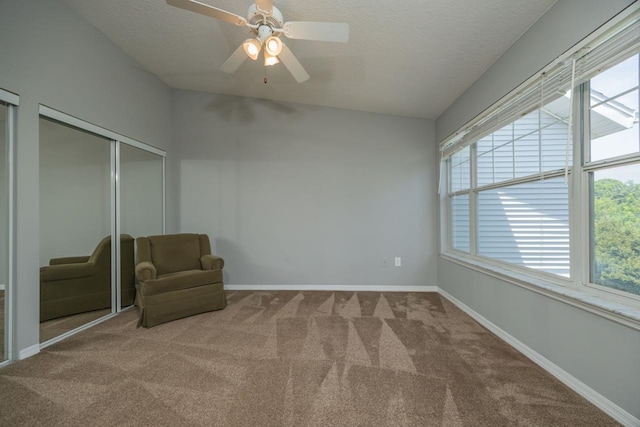 unfurnished room featuring carpet, ceiling fan, and a textured ceiling