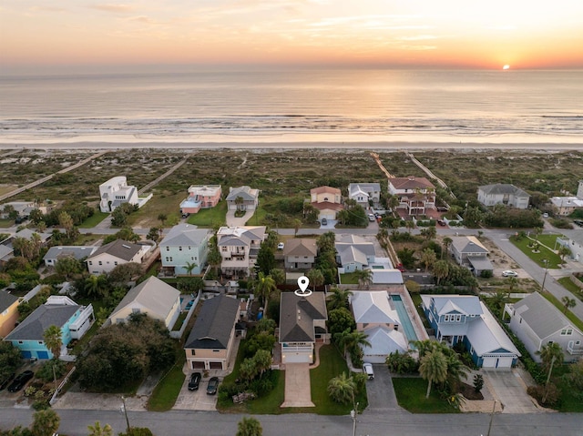 bird's eye view featuring a view of the beach, a water view, and a residential view