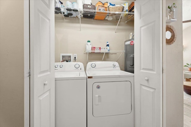 laundry room featuring laundry area, separate washer and dryer, and electric water heater