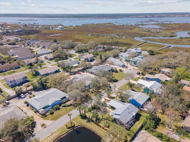 drone / aerial view with a water view and a residential view