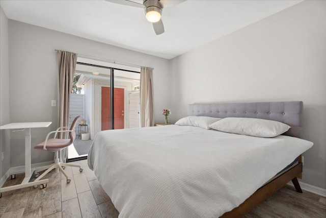 bedroom with access to outside, wood finished floors, a ceiling fan, and baseboards