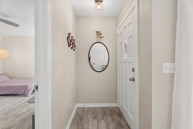 interior space featuring baseboards and wood finished floors