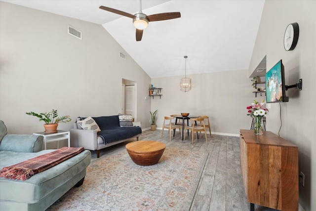 living area with ceiling fan, baseboards, visible vents, and light wood-style floors