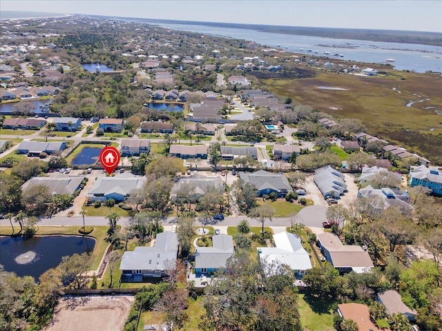 birds eye view of property with a water view and a residential view