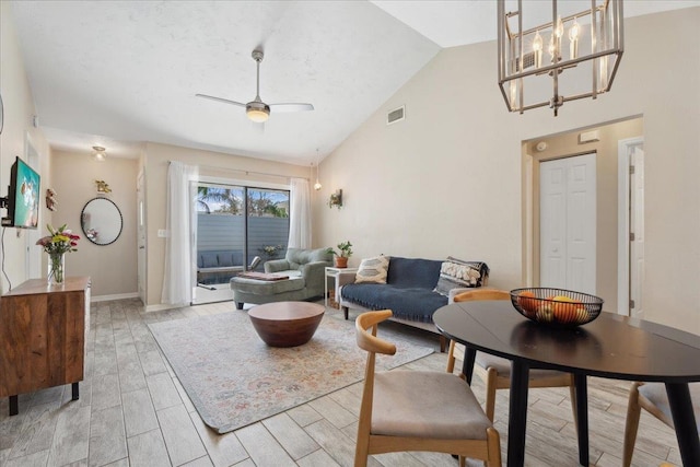 living room featuring wood finish floors, visible vents, ceiling fan, high vaulted ceiling, and baseboards