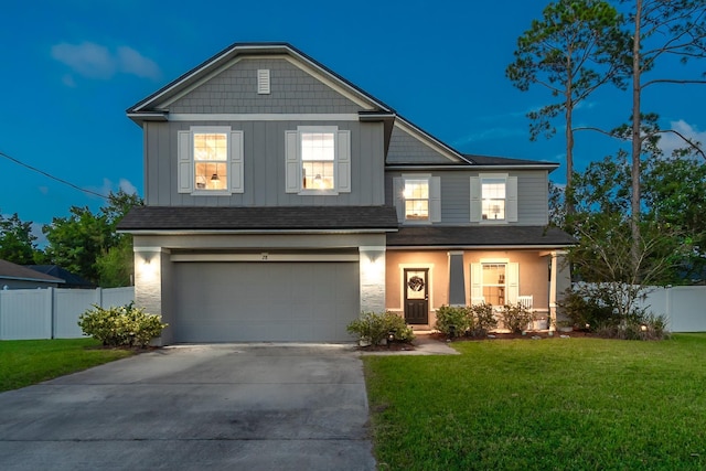 view of front of home with a garage and a front lawn