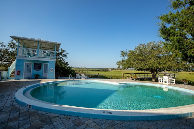 view of swimming pool featuring a patio area