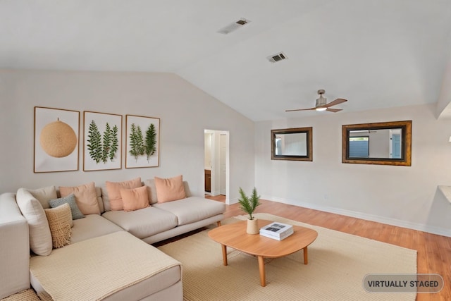 living room with ceiling fan, hardwood / wood-style floors, and vaulted ceiling