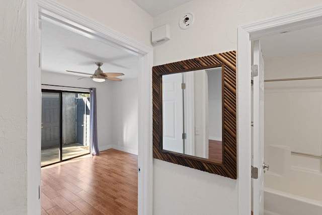 interior space with ceiling fan and wood-type flooring