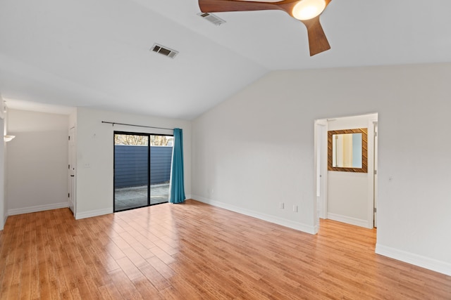 spare room featuring ceiling fan, light wood-type flooring, and vaulted ceiling