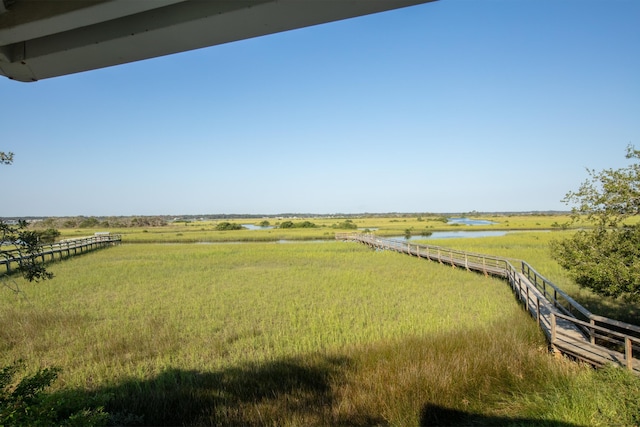 view of yard featuring a rural view and a water view