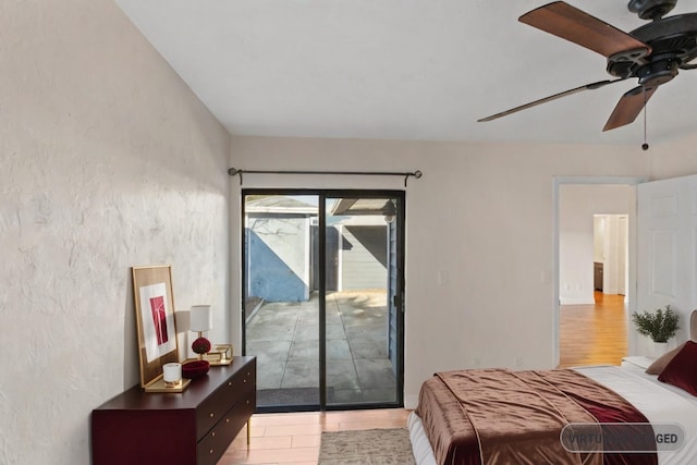 bedroom featuring ceiling fan, light hardwood / wood-style flooring, and access to outside