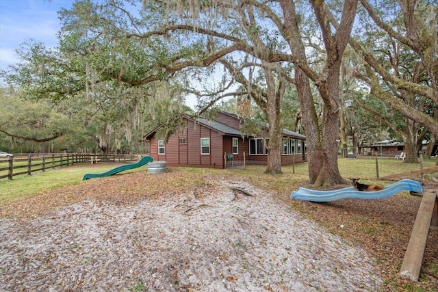 view of yard with a playground and fence