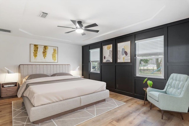 bedroom featuring visible vents, ceiling fan, and light wood-style floors