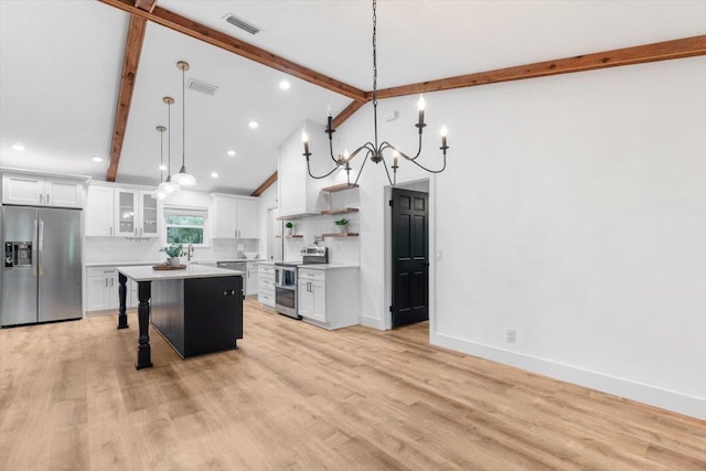 kitchen with light wood finished floors, tasteful backsplash, light countertops, appliances with stainless steel finishes, and a kitchen breakfast bar