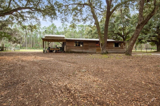 exterior space featuring an attached carport and metal roof