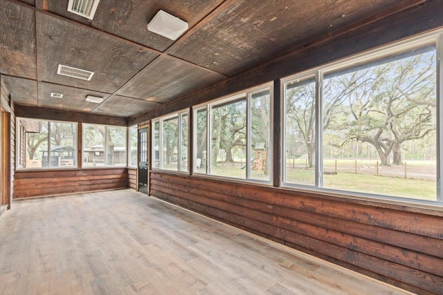 unfurnished sunroom with visible vents