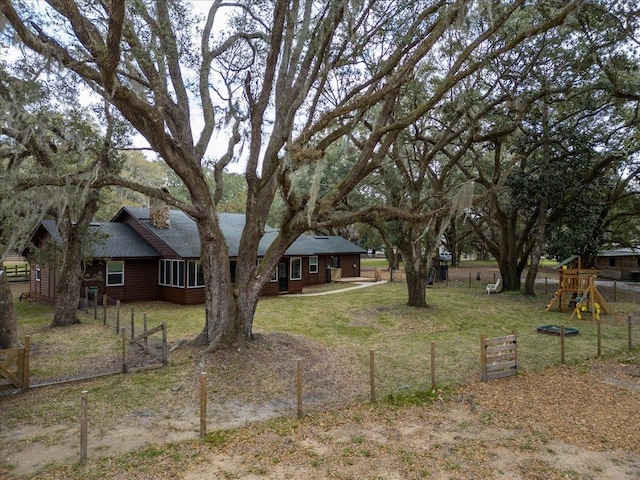 view of yard featuring a playground and fence