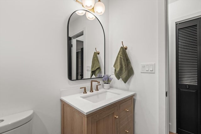 bathroom with toilet and vanity