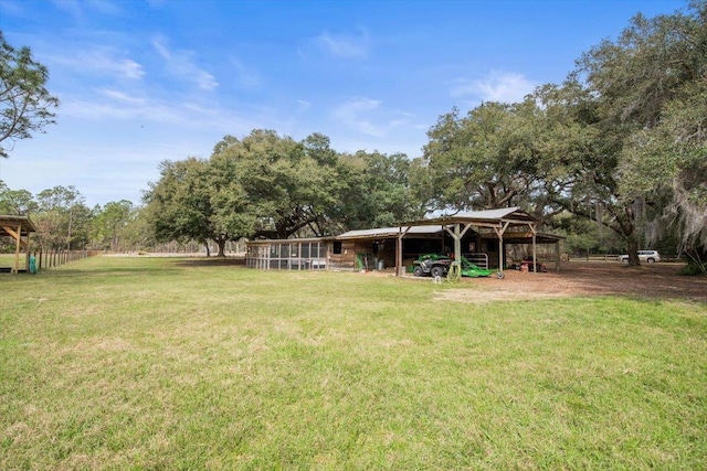 view of yard with a carport and an outdoor structure