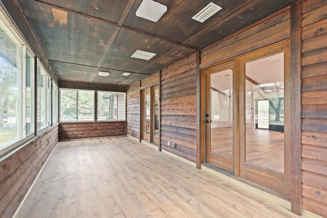 unfurnished sunroom with wooden ceiling and visible vents