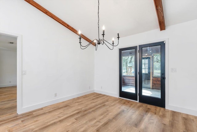 unfurnished dining area with visible vents, a notable chandelier, lofted ceiling with beams, wood finished floors, and baseboards