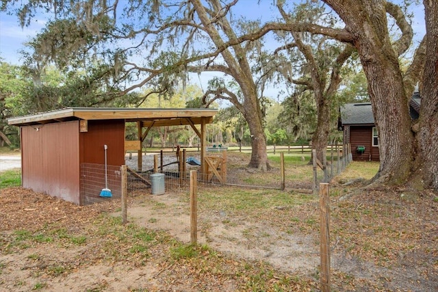 view of yard with an outdoor structure and fence