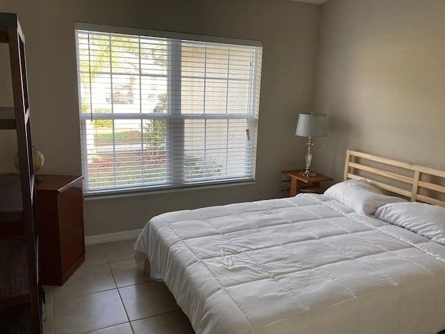 52 Fanshawe Ln, Palm Coast, FL 32137 - bedroom with light tile patterned floors and baseboards