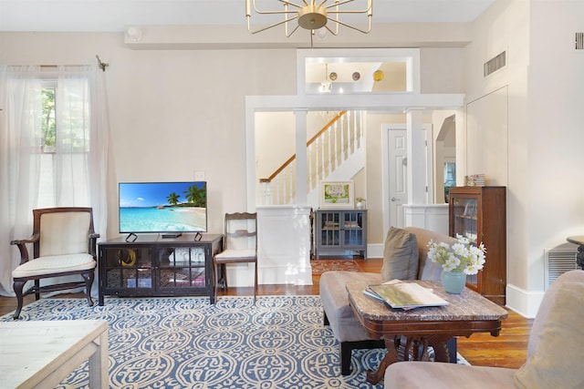 7 Cincinnati Ave, Saint Augustine, FL 32084 - living room featuring stairs, wood finished floors, and a chandelier