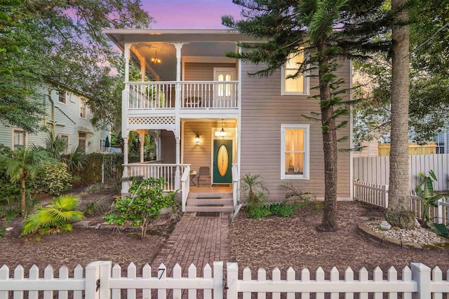 7 Cincinnati Ave, Saint Augustine, FL 32084 - view of front of home featuring covered porch, a balcony, and a fenced front yard