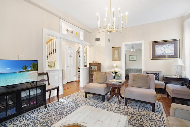 7 Cincinnati Ave, Saint Augustine, FL 32084 - living area with wood finished floors, stairway, a chandelier, and decorative columns