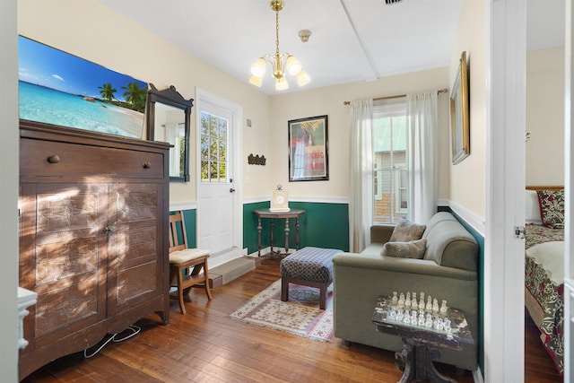 7 Cincinnati Ave, Saint Augustine, FL 32084 - living area featuring a chandelier, wood-type flooring, wainscoting, and healthy amount of natural light
