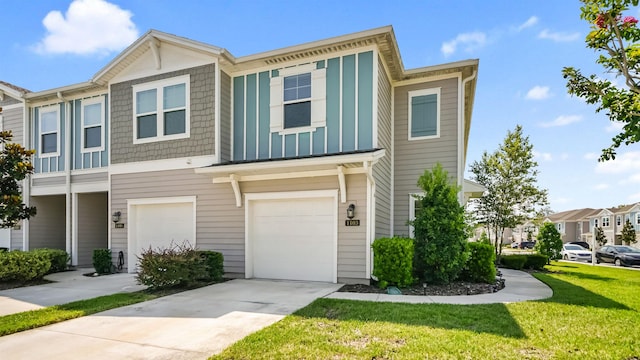 townhome / multi-family property with a front yard and a garage