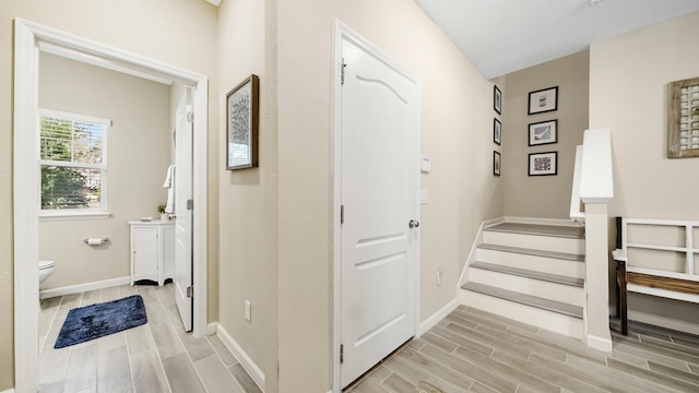 hallway with light hardwood / wood-style floors