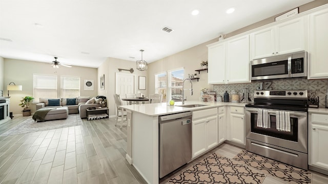 kitchen featuring white cabinetry, sink, plenty of natural light, and appliances with stainless steel finishes