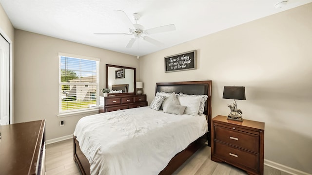 bedroom with light wood-type flooring and ceiling fan