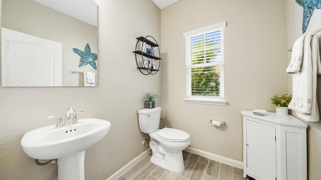 bathroom featuring hardwood / wood-style floors, toilet, and sink