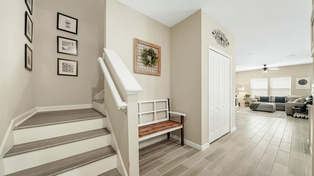 stairs with ceiling fan and wood-type flooring