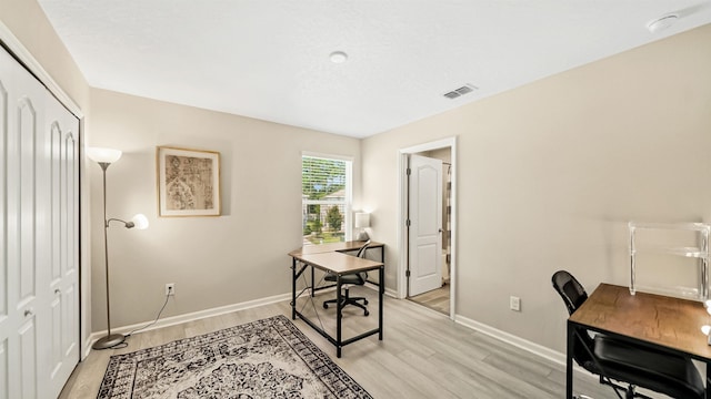 office space with light hardwood / wood-style flooring