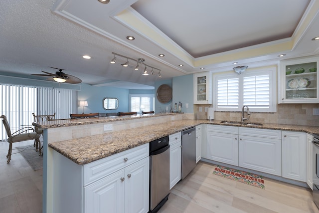 850 A1A Beach Blvd Unit 74, Saint Augustine Beach, FL 32080 - kitchen with stainless steel dishwasher, a peninsula, white cabinets, glass insert cabinets, and ceiling fan