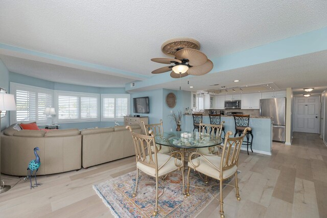 850 A1A Beach Blvd Unit 74, Saint Augustine Beach, FL 32080 - dining area with light wood-style floors, a ceiling fan, and a textured ceiling