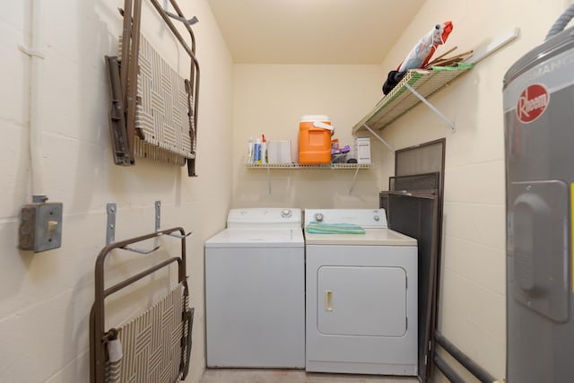 laundry room with electric water heater and separate washer and dryer