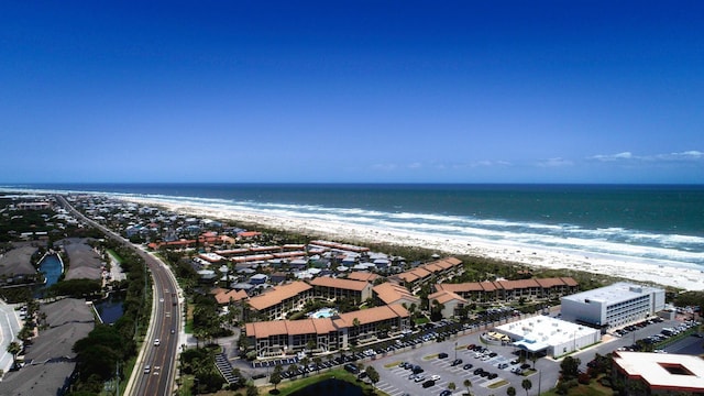 aerial view with a water view and a beach view