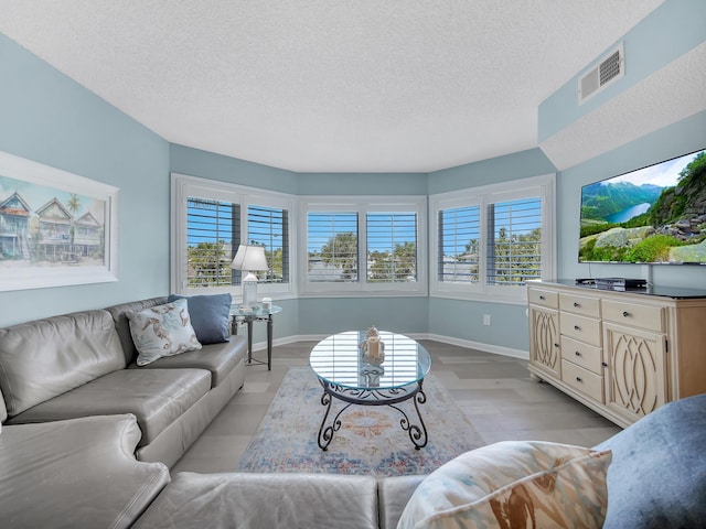 850 A1A Beach Blvd Unit 74, Saint Augustine Beach, FL 32080 - living room featuring a textured ceiling and baseboards