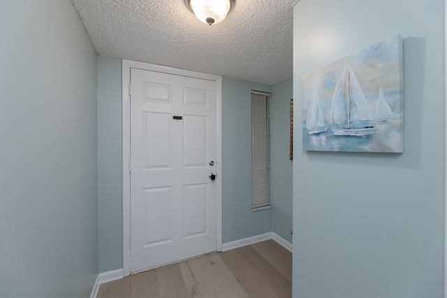 850 A1A Beach Blvd Unit 74, Saint Augustine Beach, FL 32080 - hallway featuring a textured ceiling, light wood finished floors, and baseboards
