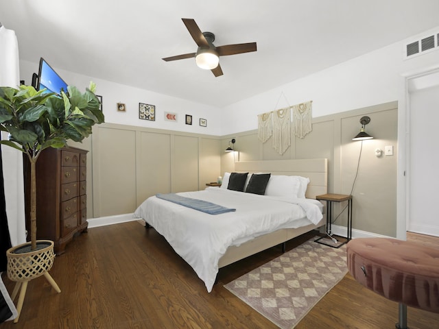 1221 A1A S, Saint Augustine, FL 32080 - bedroom with a decorative wall, wood finished floors, a ceiling fan, and wainscoting