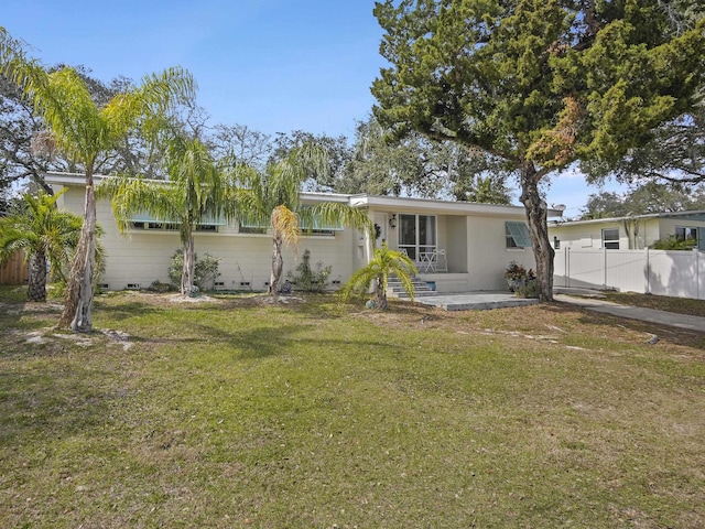 view of front of property featuring a front yard, crawl space, and fence