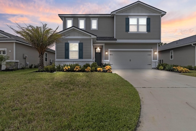 view of front facade with a yard and a garage